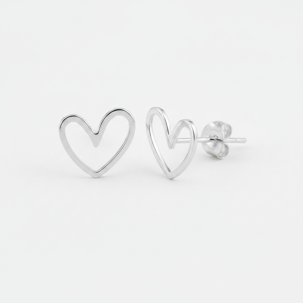 Clean Sterling Silver Heart Earrings on White Paper Background