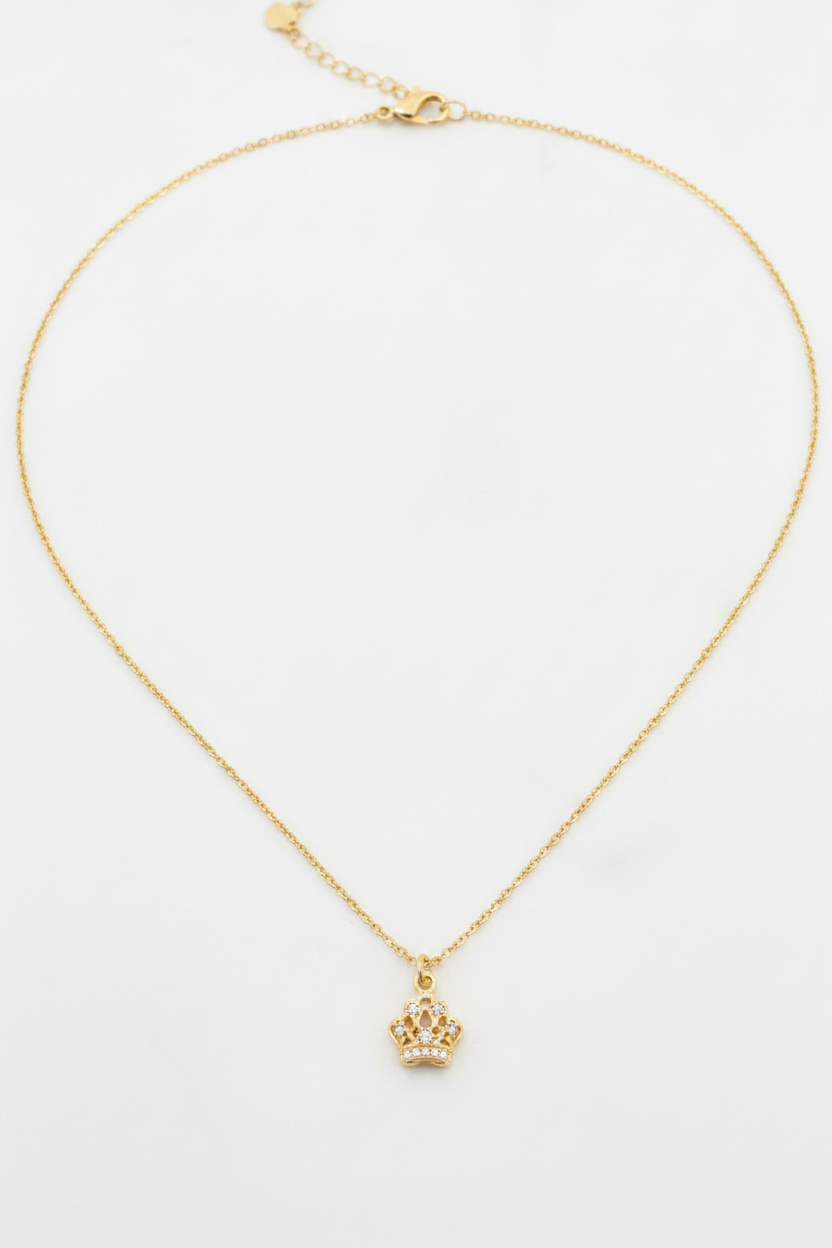Clean product shot - gold crown charm necklace on white background